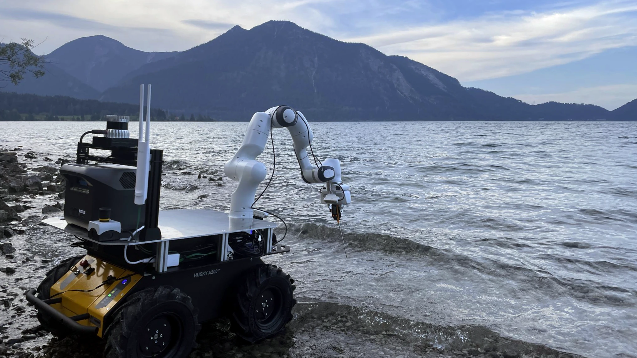 Environmental monitoring robot lowering a measurement instrument into lake water